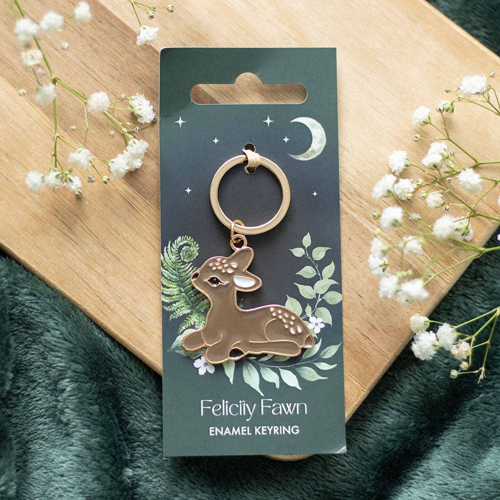 Enamel keychain of a baby deer woodland critter on a backing card labeled Felicity Fawn.