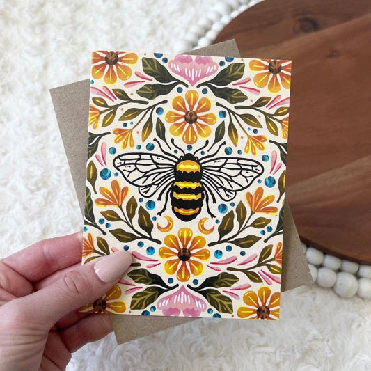 A greeting card hand drawn with a bee and floral design.