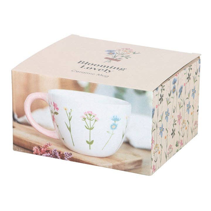 The box that the "Blooming Lovely" floral mug comes in, featuring a photo of the mug and a floral pattern on the side.