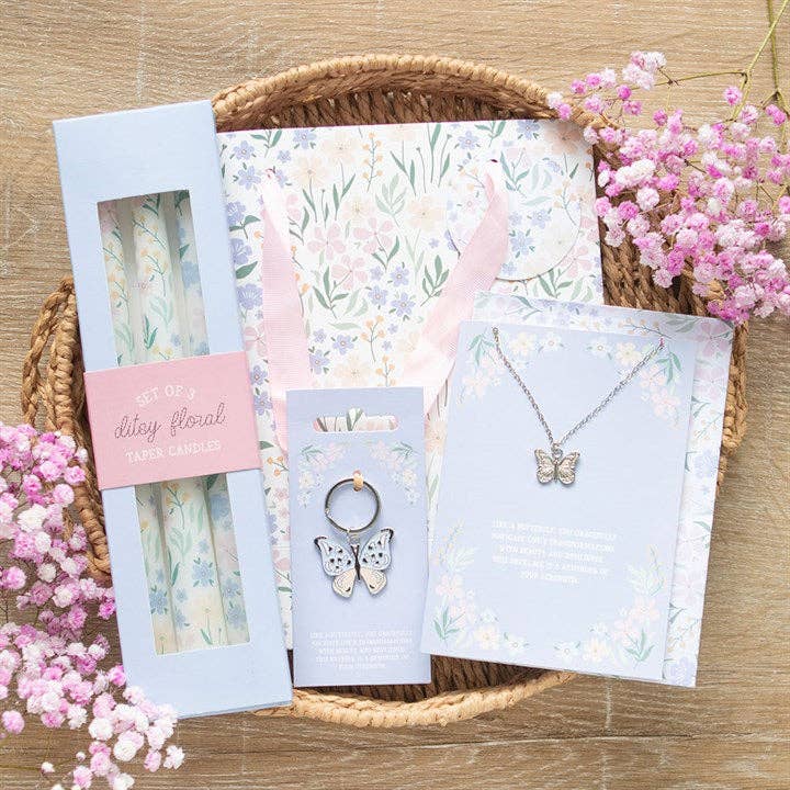 Collection of items that are butterfly and floral themed, including a butterfly keychain, butterfly necklace floral candles, and a floral gift bag. Photo included for size reference and aesthetics.