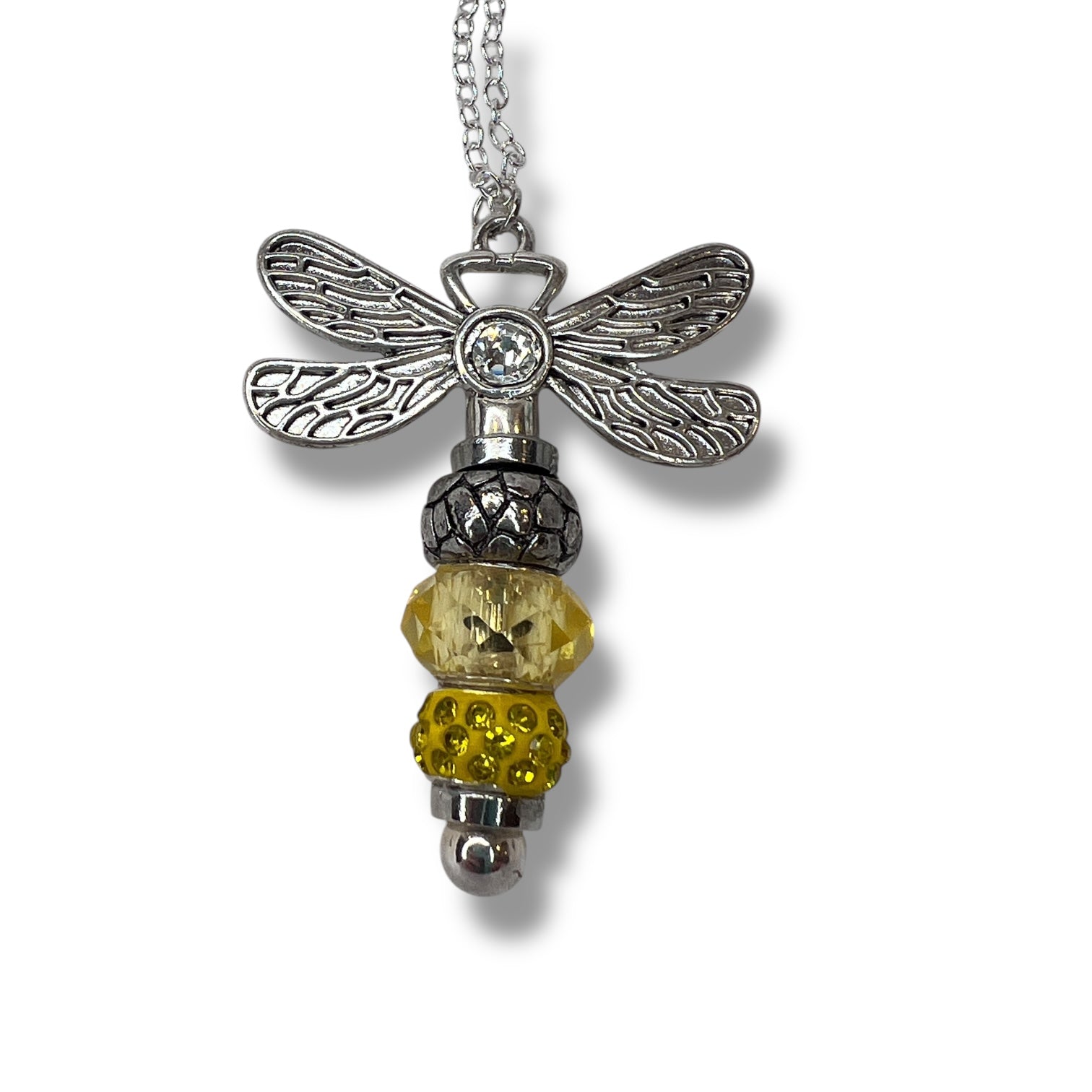 Handmade dragonfly necklace with a yellow beaded tail.