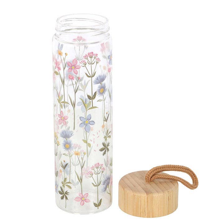 Floral glass water bottle with a bamboo lid and carrying loop.