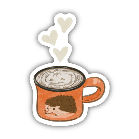 A sticker of a mug with a hedgehog on it, with steaming coffee inside