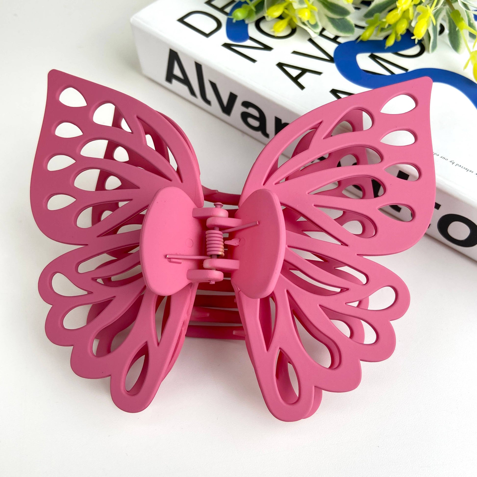 Large butterfly hair claw in dark pink.