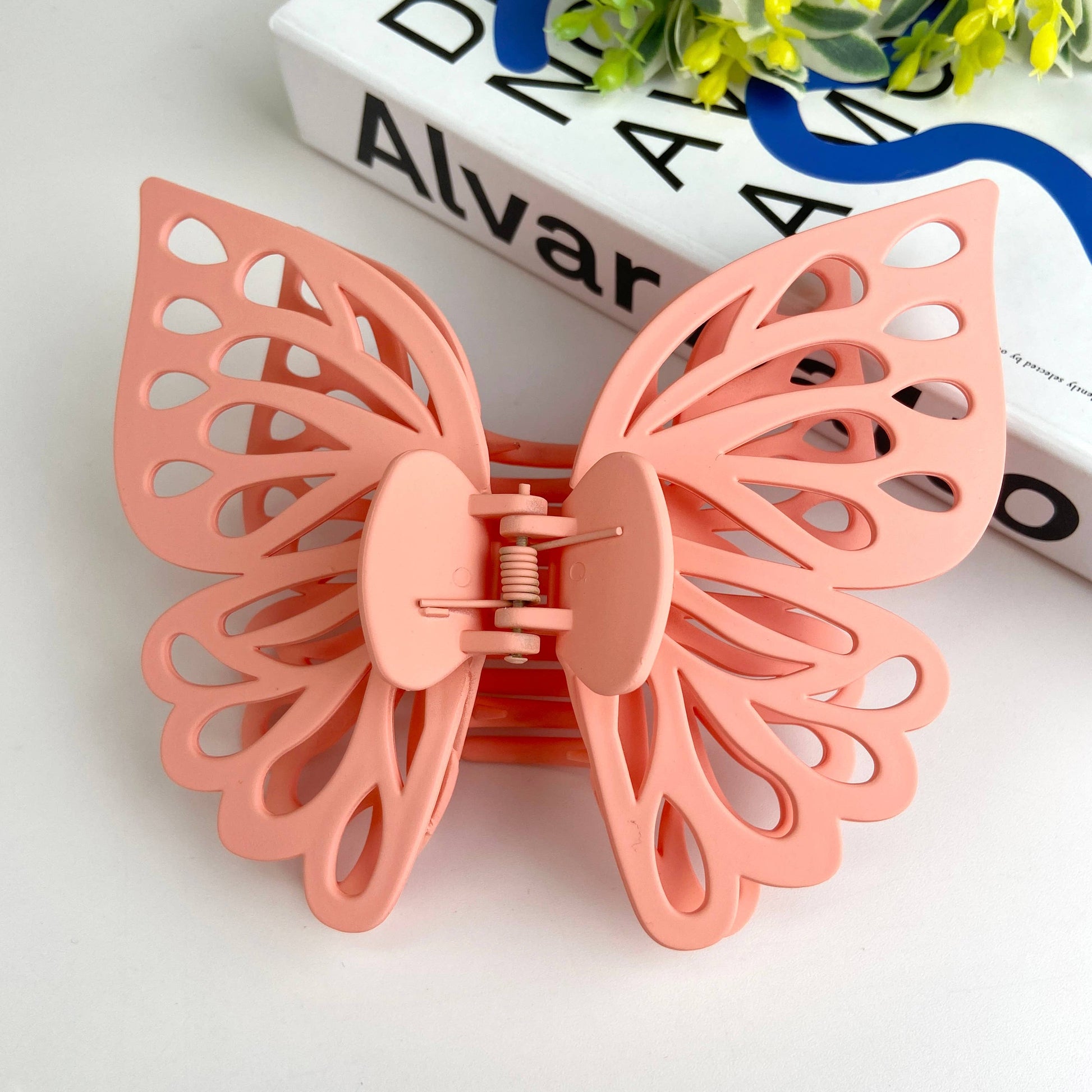 Large butterfly hair claw in light pink.