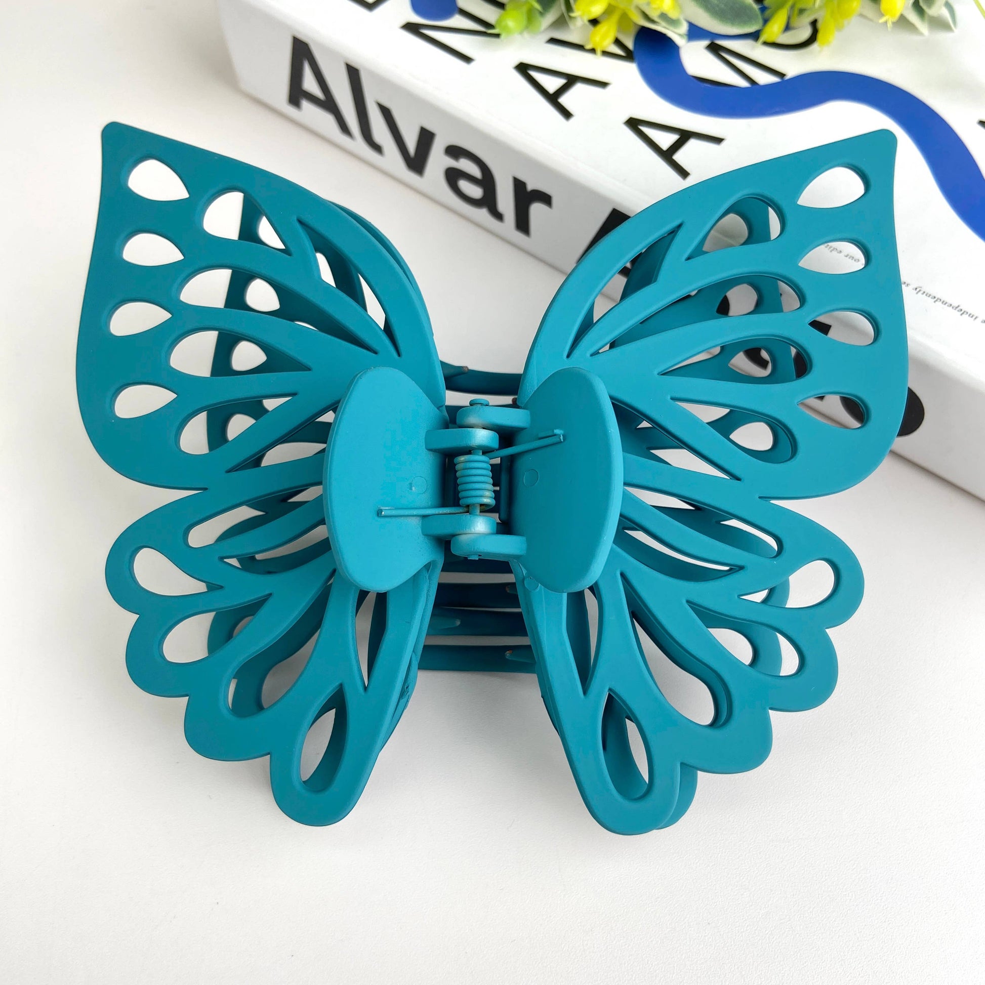 Large butterfly hair claw in turquoise blue.