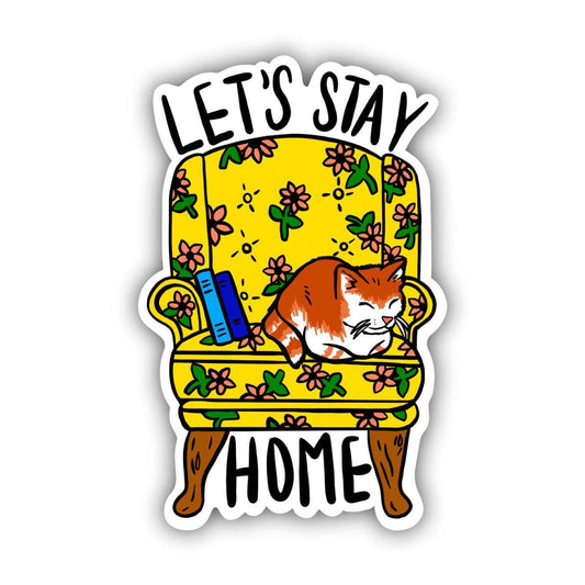 Sticker with a cat sitting in an armchair that says "Let's Stay Home." Designed by Eska and the Alpenglow