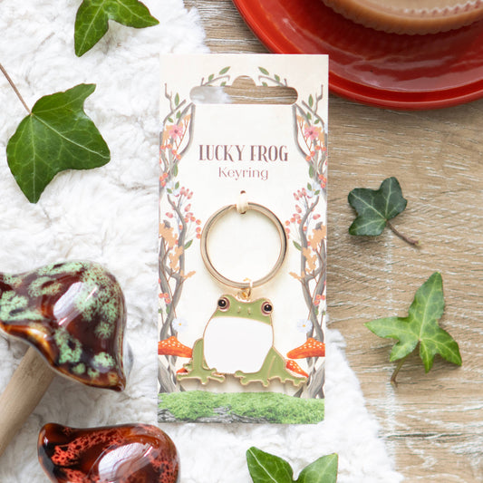 Adorable lucky frog keychain on forest backing card.