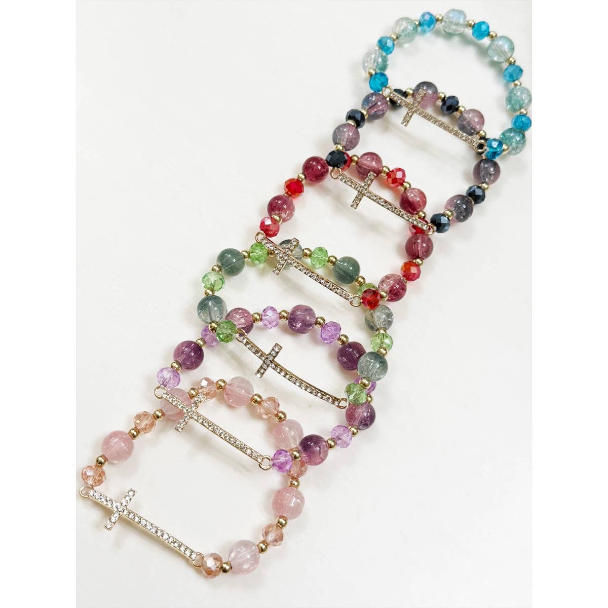 Top view of rhinestone cross beaded stretch bracelet in six colors.