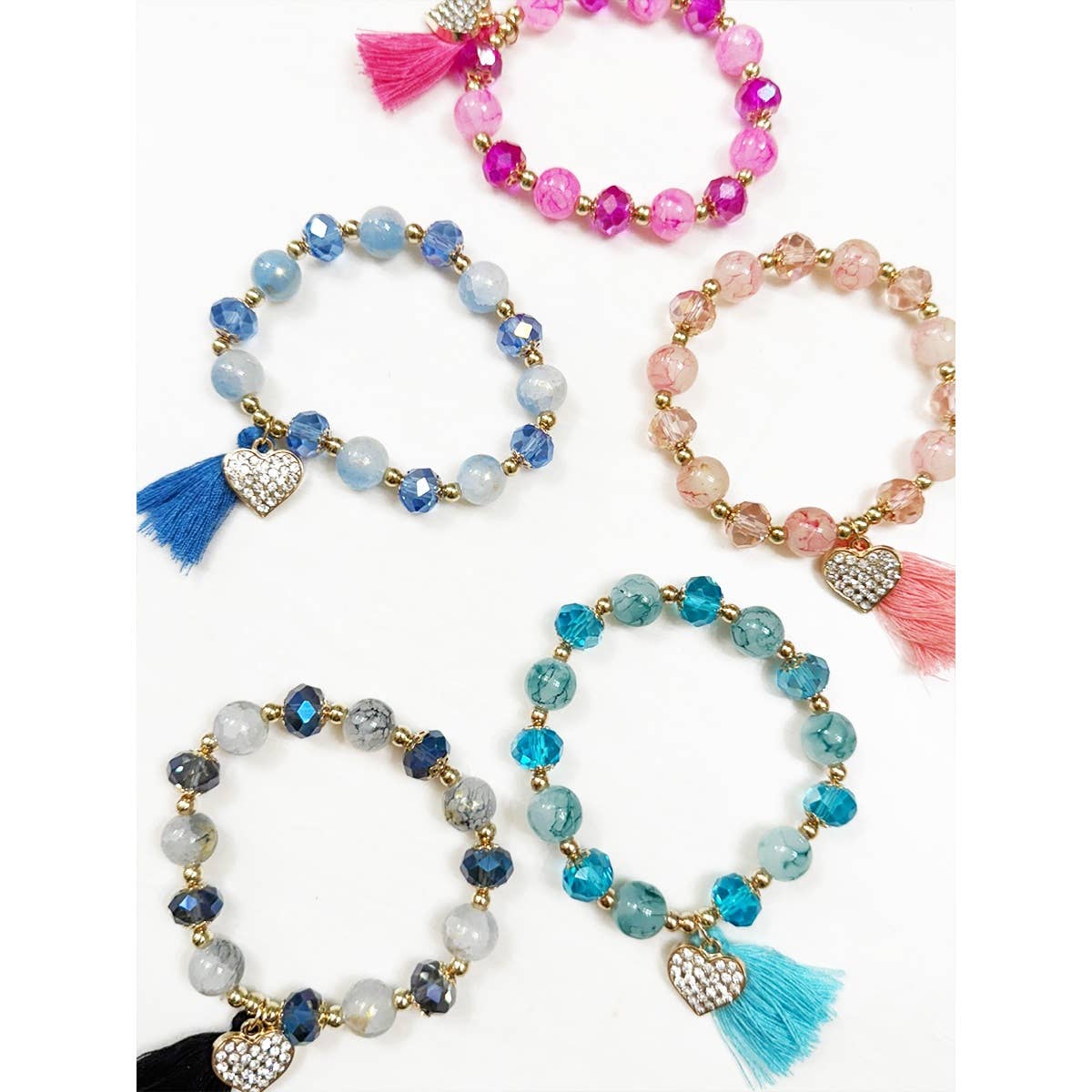 Beaded stretch bracelet with a rhinestone heart and matching tassel.