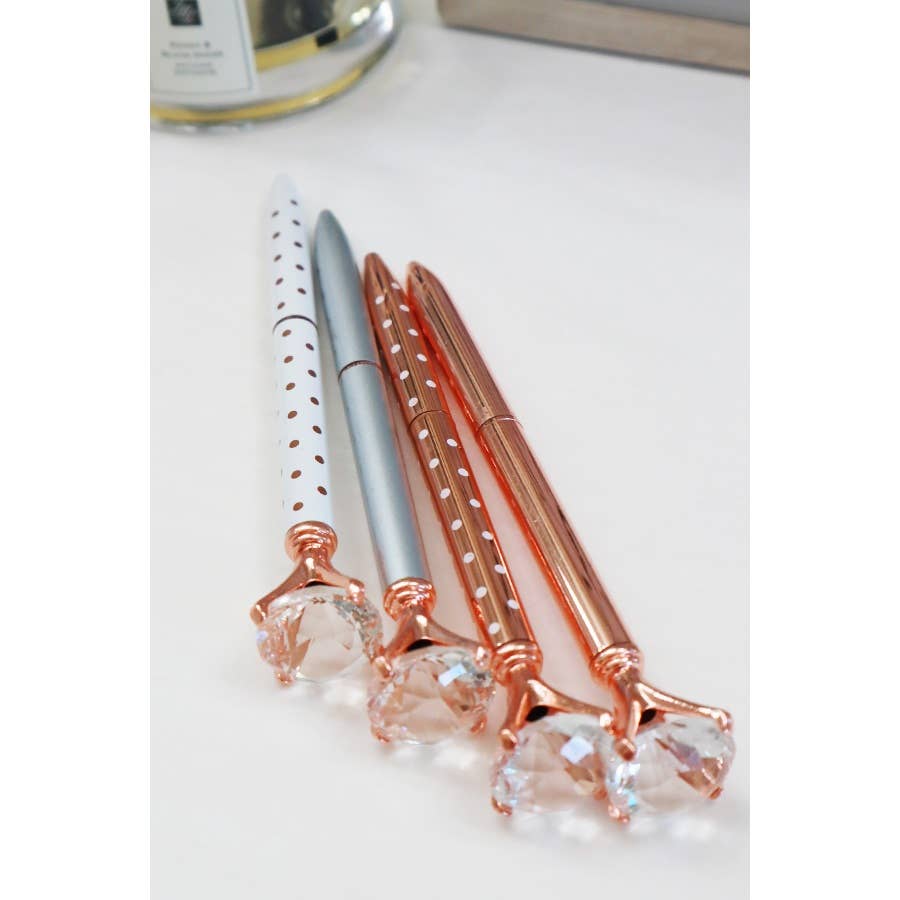 A sleek metallic pen with a large diamond on the end.