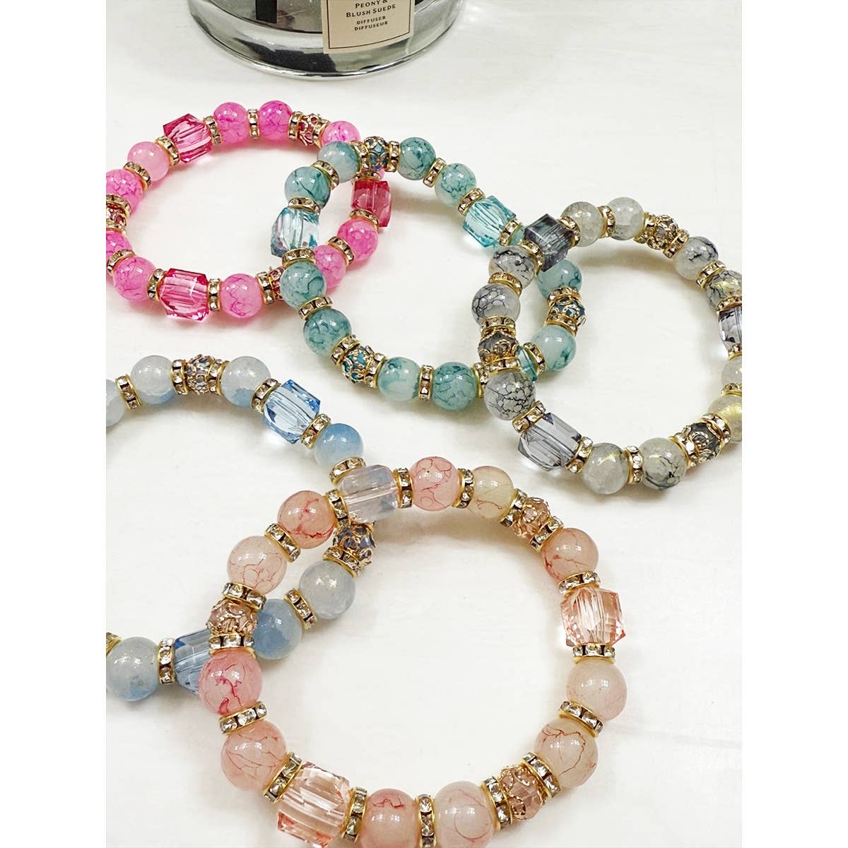 Elegant beaded bracelet with gold swirls and crackle effect.