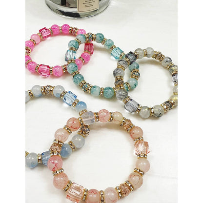 Elegant beaded bracelet with gold swirls and crackle effect.