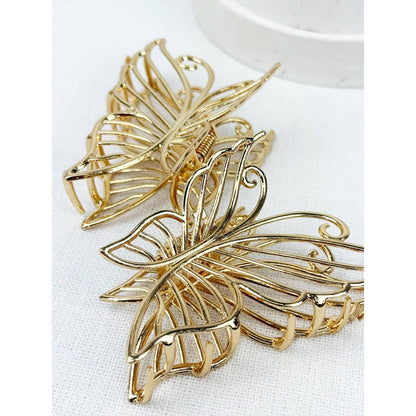 Close up of gold metal butterfly hair claw.