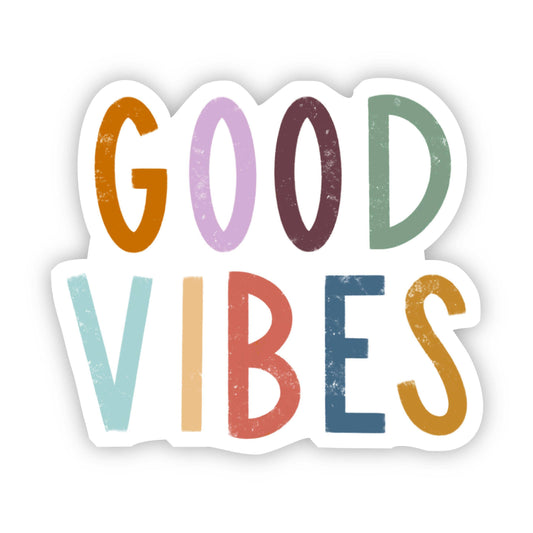 A sticker with the phrase "Good Vibes" in multicolor lettering.