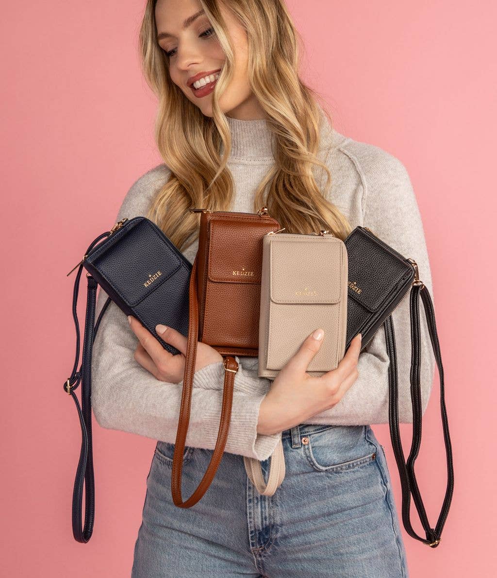 Woman holding all four colors of the eclipse smartphone crossbody bag by Kedzie.